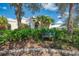 The Tennis Center boasts lush landscaping and a welcoming sign, nestled among mature trees at 5 Barbados Rd # 31, Englewood, FL 34223