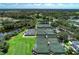 Aerial view showcases several tennis and pickleball courts with lush greenery in a vibrant recreational area at 5 Barbados Rd # 31, Englewood, FL 34223