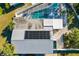 Aerial view of house featuring a pool enclosure, solar panel, and well-maintained grounds at 503 Roberts Bay Dr, Nokomis, FL 34275