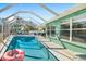 Enclosed swimming pool area with a pool and outdoor lounge chairs at 503 Roberts Bay Dr, Nokomis, FL 34275