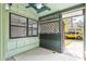 Enclosed patio with concrete flooring and view of a yellow car in the drive at 5084 Barrington Cir # 3202, Sarasota, FL 34234