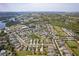 An aerial view shows a Primary-planned community featuring a neighborhood pond and lush green spaces at 5234 Aqua Breeze Dr, Bradenton, FL 34208