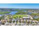 An aerial view highlights a well-maintained community lawn surrounded by a mix of residential and recreational spaces at 5234 Aqua Breeze Dr, Bradenton, FL 34208