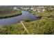 An aerial view features a community dock in a picturesque natural setting with lush greenery and a winding waterway at 5234 Aqua Breeze Dr, Bradenton, FL 34208