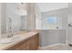 Bright bathroom with double sinks, a large mirror, and a glass-enclosed shower at 5234 Aqua Breeze Dr, Bradenton, FL 34208
