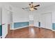 Spacious bedroom features wood floors, a ceiling fan, and double closet doors at 5234 Aqua Breeze Dr, Bradenton, FL 34208