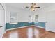 Bedroom showcasing wood floors, ample natural light, and a decorative two-tone wall design at 5234 Aqua Breeze Dr, Bradenton, FL 34208