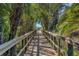 A wooden boardwalk with railings winds through a lush, green environment at 5234 Aqua Breeze Dr, Bradenton, FL 34208