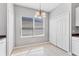 Cozy dining area featuring a modern chandelier, a large window, and convenient access to closet space at 5234 Aqua Breeze Dr, Bradenton, FL 34208