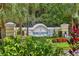 A welcoming entrance sign is nestled amidst lush foliage, creating a warm and inviting feel at 5234 Aqua Breeze Dr, Bradenton, FL 34208