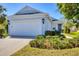 Beautiful home featuring lush landscaping, a wide driveway, and a pristine two-car garage on a sunny day at 5234 Aqua Breeze Dr, Bradenton, FL 34208