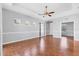 Spacious living area with wood floors, neutral walls, and a tray ceiling with a fan for comfortable living at 5234 Aqua Breeze Dr, Bradenton, FL 34208