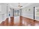 Bright living room with hardwood floors, transom windows, and sliding glass doors leading to the outdoor space at 5234 Aqua Breeze Dr, Bradenton, FL 34208