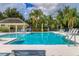 Community pool features a pavilion, lounge chairs, and well-maintained landscaping with palm trees at 5234 Aqua Breeze Dr, Bradenton, FL 34208