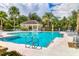 Community pool with a covered pavilion, lounge chairs and well-maintained landscaping at 5234 Aqua Breeze Dr, Bradenton, FL 34208