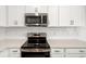 Modern kitchen with stainless steel oven and microwave, and white subway tile backsplash at 5533 Patano Loop, Palmetto, FL 34221