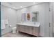 Modern bathroom featuring double sinks, quartz countertops, updated cabinets and a large mirror at 5655 Pipers Waite # 27, Sarasota, FL 34235