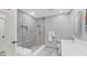 Modern bathroom with gray tile, glass-enclosed shower, and sleek vanity at 5655 Pipers Waite # 27, Sarasota, FL 34235