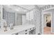 Well-lit bathroom with a spacious vanity and decorative wallpaper at 5655 Pipers Waite # 27, Sarasota, FL 34235
