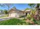 Charming home exterior with a well-manicured lawn, attached garage and decorative landscaping at 5655 Pipers Waite # 27, Sarasota, FL 34235