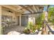 Covered lanai with stone pavers and lush landscaping creating a private outdoor oasis at 5655 Pipers Waite # 27, Sarasota, FL 34235