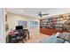 Bright home office featuring built-in bookshelves and a comfortable workspace at 5655 Pipers Waite # 27, Sarasota, FL 34235