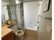Bathroom featuring a tub/shower with curtain and grab bar for accessibility at 5962 Roseto Pl, Sarasota, FL 34238