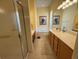 Bathroom with a walk-in shower, garden tub, and double sink vanity at 5962 Roseto Pl, Sarasota, FL 34238