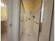 Bright bathroom featuring a white walk-in shower with glass doors and grab bars at 5962 Roseto Pl, Sarasota, FL 34238
