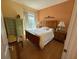 Comfortable bedroom with wood floors, nice lamps, decorative chest and a window at 5962 Roseto Pl, Sarasota, FL 34238