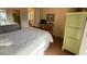 Comfortable bedroom featuring a queen size bed with sliding door closet and hard wood floors at 5962 Roseto Pl, Sarasota, FL 34238