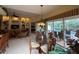 Open-concept dining area with view to the pool, kitchen, and living space at 5962 Roseto Pl, Sarasota, FL 34238