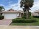 Charming single-story home featuring a tile roof, manicured landscaping, and a two-car garage at 5962 Roseto Pl, Sarasota, FL 34238