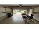 Well-lit garage with storage, workspace, and an entrance with outdoor views at 5962 Roseto Pl, Sarasota, FL 34238