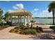 Lakefront gazebo features decorative landscaping, providing tranquil views and relaxation at 5962 Roseto Pl, Sarasota, FL 34238
