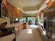 Spacious kitchen with light wood cabinets, long counters, and stainless steel appliances at 5962 Roseto Pl, Sarasota, FL 34238