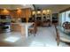 Open kitchen with light wood cabinetry, barstool seating, and view to the living space at 5962 Roseto Pl, Sarasota, FL 34238