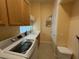 Well-equipped laundry area with a sink and lots of upper cabinets at 5962 Roseto Pl, Sarasota, FL 34238