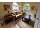 Comfortable living room with neutral tones, two windows, couch, and a coffee table at 5962 Roseto Pl, Sarasota, FL 34238