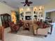 Comfortable living room with built-in shelving, decorative items, and stylish furnishings at 5962 Roseto Pl, Sarasota, FL 34238