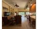 Open living room with built-in shelving and large windows overlooking the pool at 5962 Roseto Pl, Sarasota, FL 34238