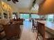 Open-concept living room with views of the pool and access to the backyard at 5962 Roseto Pl, Sarasota, FL 34238