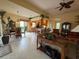 Living room and kitchen feature tile floors and large windows for natural light at 5962 Roseto Pl, Sarasota, FL 34238