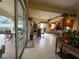 View from the living room to the kitchen and outdoor space with sliding glass doors at 5962 Roseto Pl, Sarasota, FL 34238