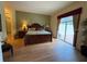 Main bedroom suite with wood floors, access to the lanai, and neutral decor at 5962 Roseto Pl, Sarasota, FL 34238