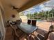 Inviting screened-in lanai with a table and chairs overlooking the pool and tropical landscape at 5962 Roseto Pl, Sarasota, FL 34238