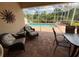Inviting covered patio with comfortable seating and a view of the sparkling pool, perfect for relaxation at 5962 Roseto Pl, Sarasota, FL 34238
