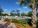 Community playground featuring slides, climbing structures, and a secure fenced area at 5962 Roseto Pl, Sarasota, FL 34238