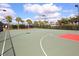 Community tennis court, surrounded by mature trees, offers an active outdoor amenity at 5962 Roseto Pl, Sarasota, FL 34238