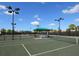 Community tennis courts with lighting and a shaded shelter for relaxing between sets at 5962 Roseto Pl, Sarasota, FL 34238